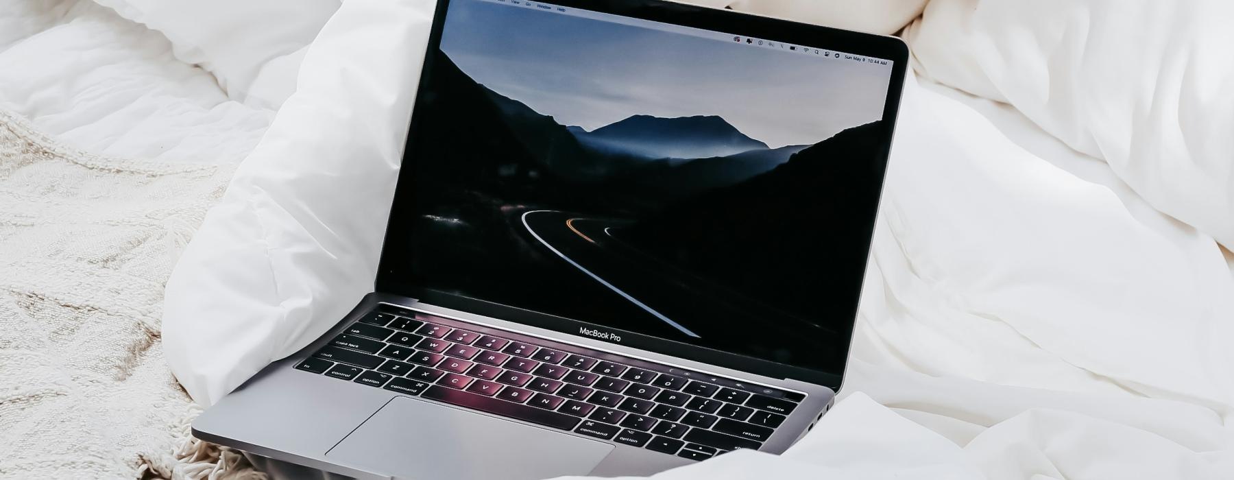 a laptop on a bed