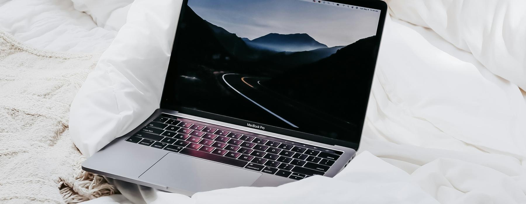 a laptop on a bed